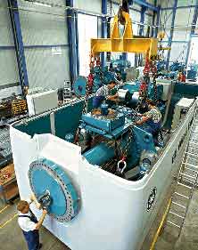 GE workers in Germany put the finishing touches on a GE 1.5 MW turbine. A new production line will boost capacity.