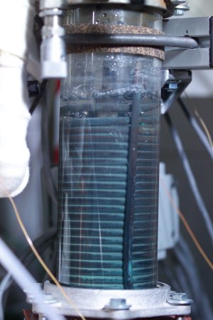 Bubbles of hydrogen (along with residual steam and nitrogen carrier gas) are seen coming from the high temperature electrolysis cell. Cooling coils condense steam, cool the hydrogen and allow for the safe exhausting of the hydrogen. Bubbles of hydrogen (along with residual steam and nitrogen carrier gas) are seen coming from the high temperature electrolysis cell. Cooling coils condense steam, cool the hydrogen and allow for the safe exhausting of the hydrogen.