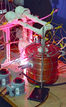 Button cell testing furnace, showing the heated tubes carrying the steam to the button cell and the hydrogen away from the cell. Button cell testing furnace, showing the heated tubes carrying the steam to the button cell and the hydrogen away from the cell.