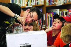 Micah Hinton, far left, talks about his hydrogen-powered model car to students, including from left, Allora Lafferty, Lukas Morgan, Terrell Strauss and BJ Morgan, at Sunnyside Elementary School on April 21. Allora, 8, is the daughter of Nicole and Michael Lafferty; Lukas, 11, and BJ, 9, are the sons of Christy and George Morgan; and Terrell, 9, is the son of Shari and Terrell Strauss.