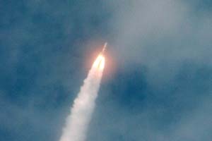 Image of NOAA GOES-N satellite being launched from the Cape Canaveral Air Force Station in Florida Wednesday aboard a Boeing Delta IV rocket trailing a plume of smoke as it roars through the thin cloud cover on its way to space.