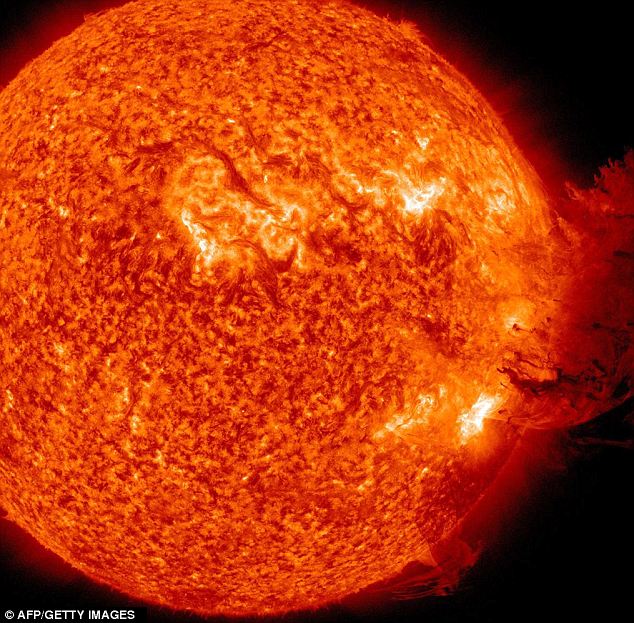 Heat is on: Solar flares spray gases out at 5million mph and at 100,000,000C. Pictured is a flare that erupted in June this year