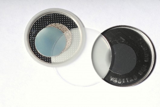 Components of a new self-charging piezoelectric power cell � the clear disc in the center ...